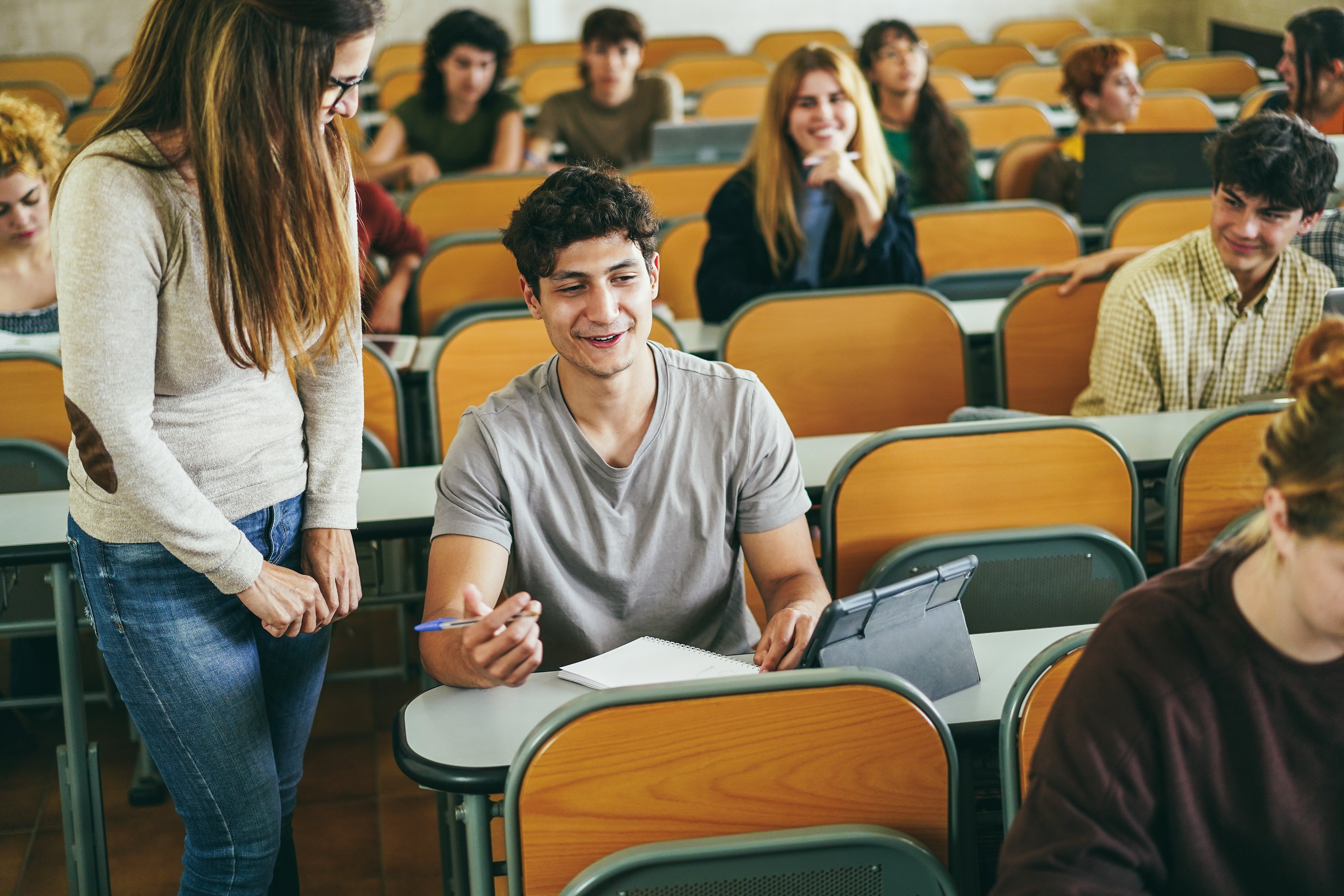 mature-teacher-working-with-students-inside-classr-2023-11-27-05-33-20-utc